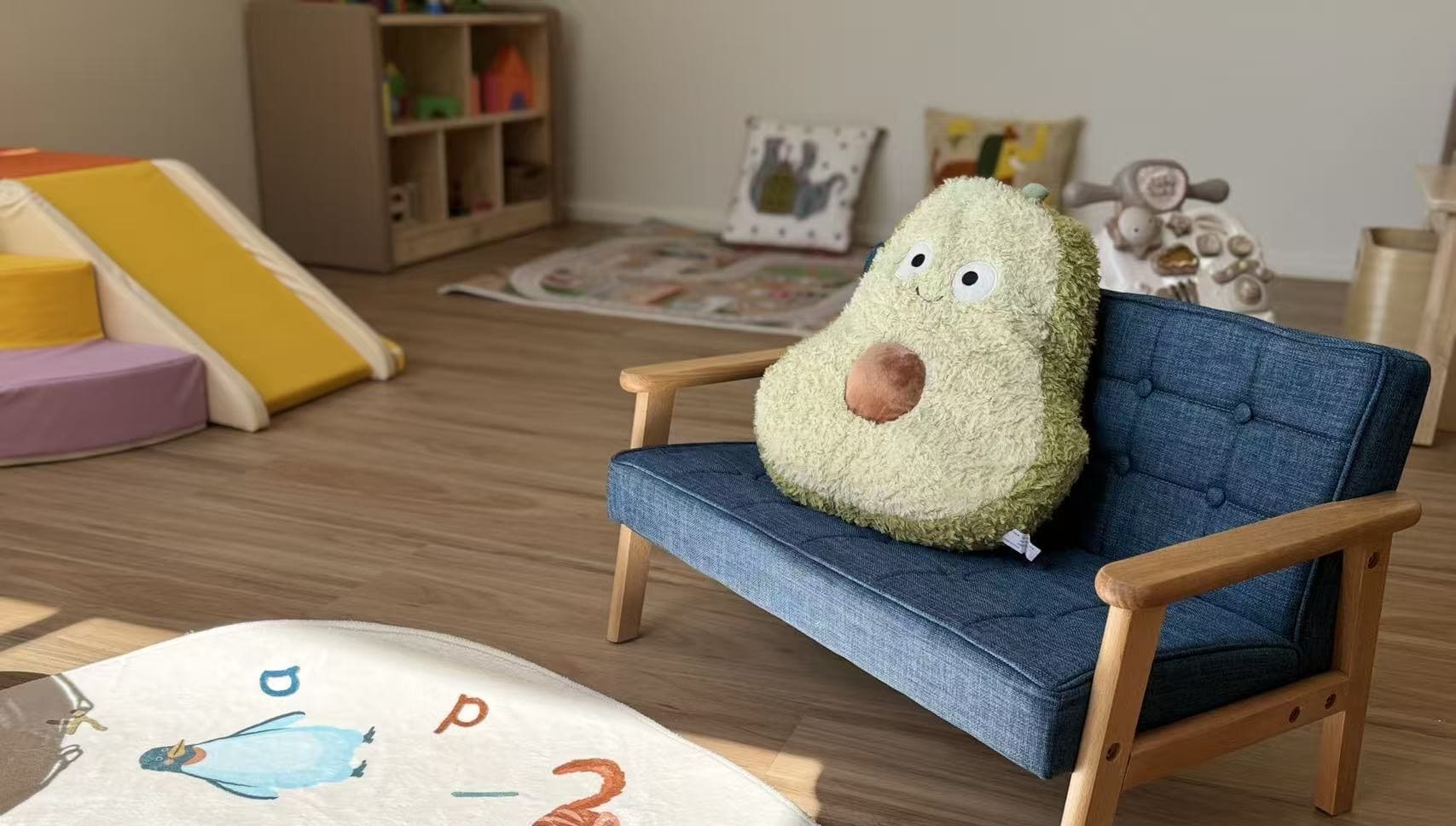 Toy avocado sitting on a chair by the window